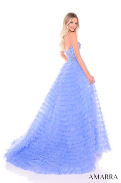 A periwinkle blue ruffled ballgown with a strapless bodice and tiered, shimmering skirt.
