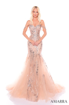 A blonde woman wears a sparkling blush pink mermaid gown with off-shoulder straps and a sweeping tulle train.