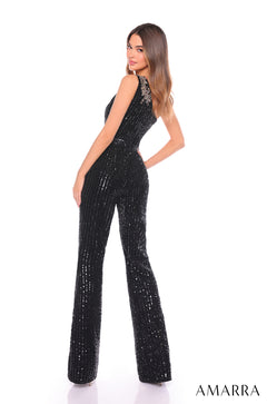 A model wears a fitted black sequin jumpsuit with wide-leg pants and an embellished shoulder detail.