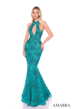 A model wears a jade mermaid-style evening gown with intricate starburst beading and a keyhole neckline.