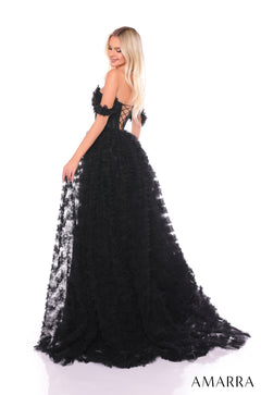 A blonde model wears a dramatic black off-shoulder gown with a ruffled skirt and corset-style bodice.