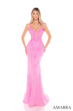 A woman wears a form-fitting, floor-length Pink lace gown with a plunging neckline and elegant silhouette.