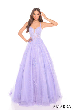 A model wears a voluminous lilac ball gown with lace details and a plunging sweetheart neckline.