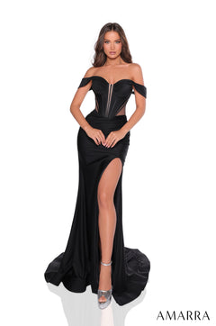 A long black off-shoulder gown with a thigh-high slit and corset-style bodice, worn with silver heels.