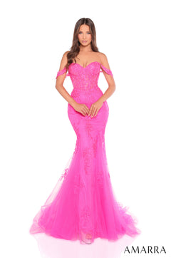 A person wearing a fuchsia mermaid-style gown with an off-shoulder lace bodice and flowing tulle skirt.