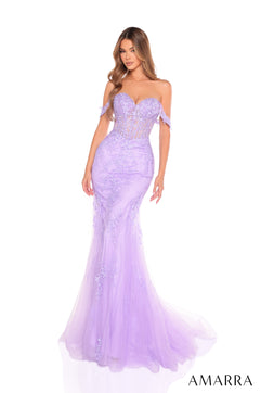 A model wears a lilac mermaid-style evening gown with delicate off-shoulder lace details and a sweeping tulle skirt.