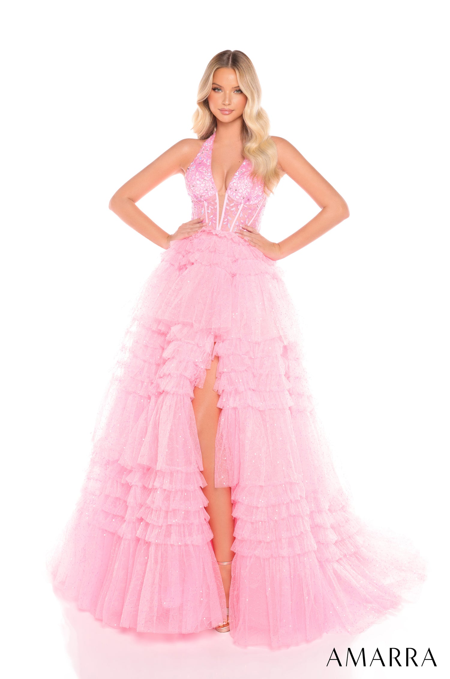 A floor-length Candy Pink tulle gown with a plunging neckline, tiered skirt, and dramatic high slit.