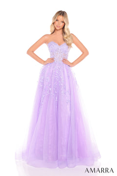 A woman wears a lilac sweetheart ballgown with floral embroidery and a full tulle skirt.