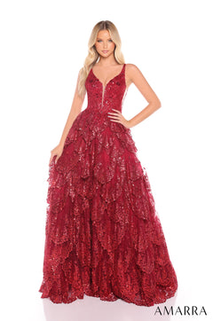 A blonde model wears a full-length wine-colored sequined ball gown with a plunging neckline and tiered skirt.