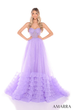 A model wears a strapless, lilac tulle ball gown with a structured bodice and ruffled tiered skirt.