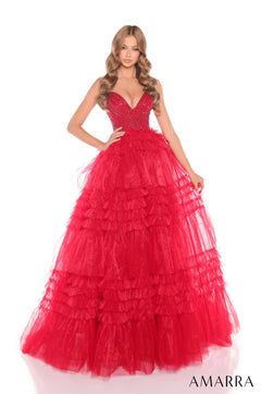 A woman wears a voluminous, tiered Red ball gown with a sparkling bodice and ruffled tulle skirt.