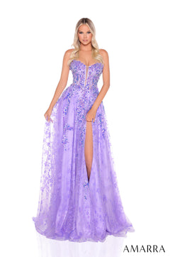 A model wears a lavender floral embellished corset ballgown with a high slit and flowing tulle skirt.