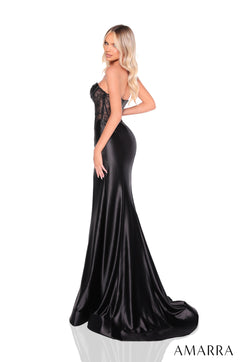A model wears a black satin strapless gown with a lace bodice and dramatic flowing train.