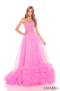 A model wears a strapless Hot Pink ball gown with a sequined bodice and voluminous tulle skirt.