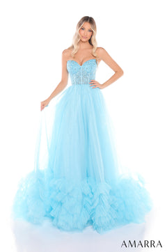 A woman wears a light blue strapless ball gown with a beaded corset top and ruffled tulle skirt.