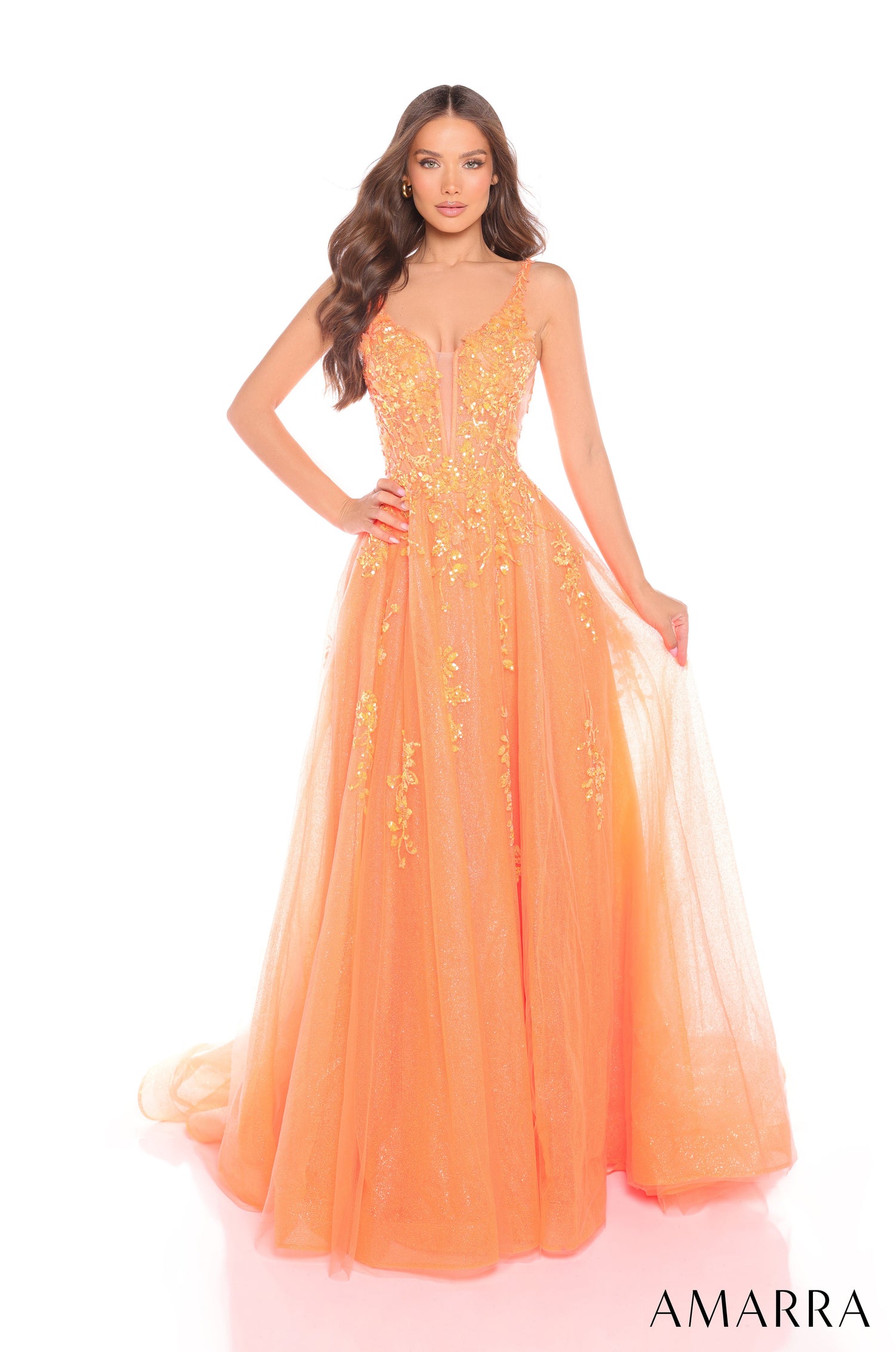 A full-length, glittery Orange ball gown with a fitted bodice and sweeping tulle skirt by Amarra.