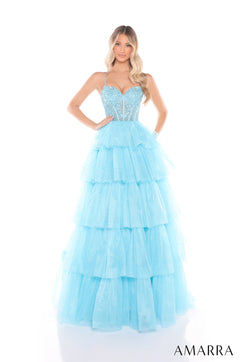A model wears a light blue tiered tulle ball gown with a beaded corset bodice.