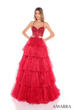 A woman wears a red tiered tulle ball gown with a beaded bustier bodice by Amarra.