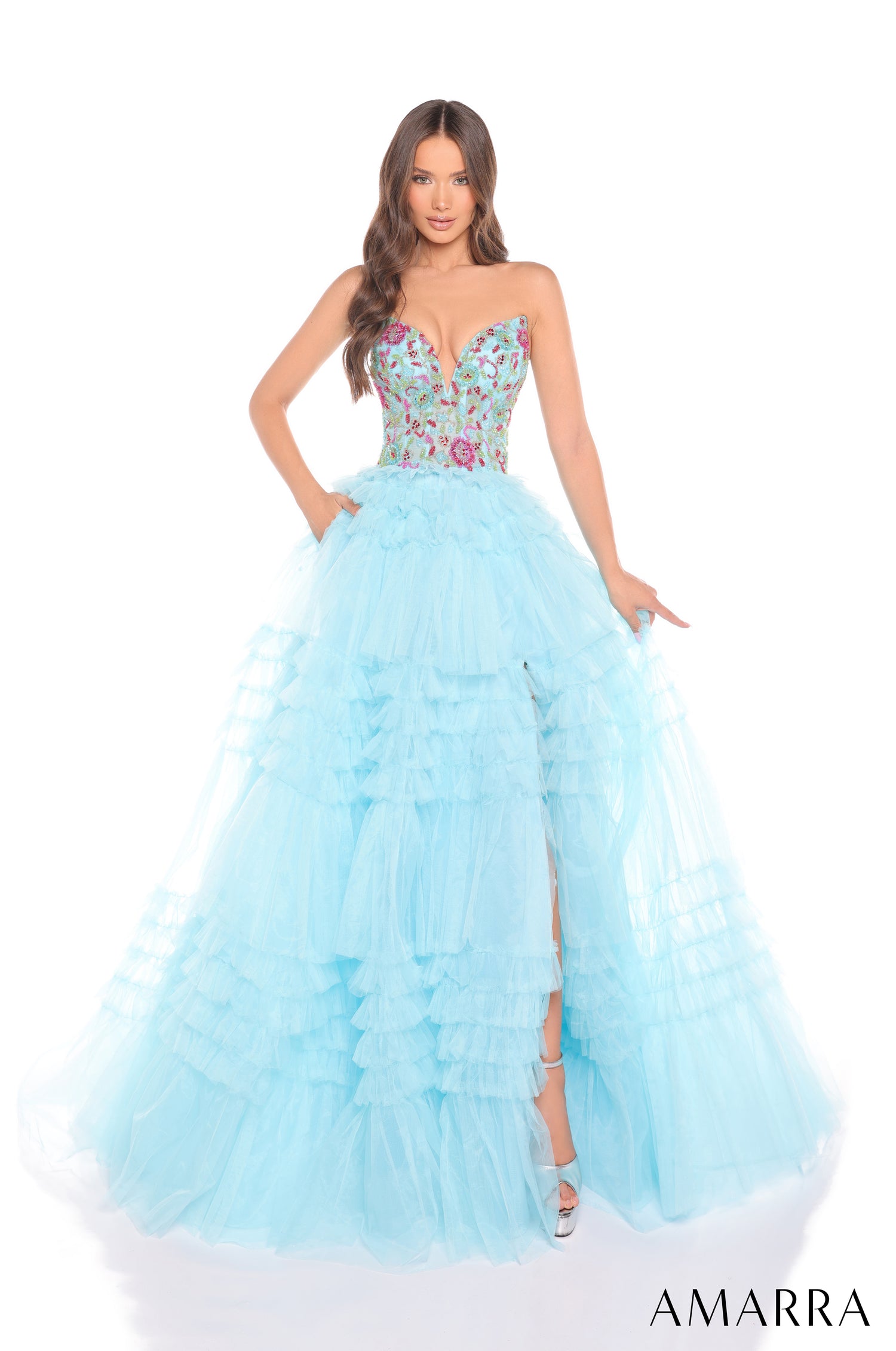 A strapless Light Blue/Multi ball gown with a floral bodice and tiered ruffled skirt, photographed on a model.