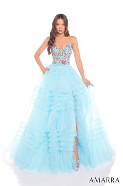 A strapless Light Blue/Multi ball gown with a floral bodice and tiered ruffled skirt, photographed on a model.