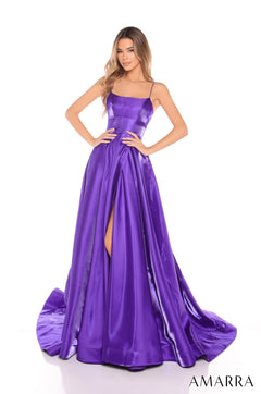A slim woman wears a long, flowing purple satin gown with a side slit and thin straps.