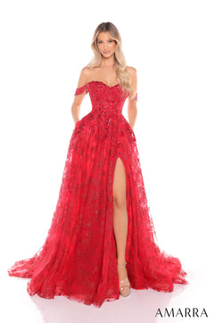 A woman wearing a long, sparkling red lace gown with an off-shoulder design and high slit.