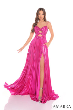 A long fuchsia gown with cutout waist, spaghetti straps, high slit, and shimmery pleated fabric.