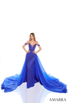 A fitted Royal Blue sequin gown with a dramatic tulle train, worn by a model against a white background.