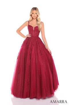 A floor-length wine ballgown with floral appliqués and a sweetheart neckline, photographed on a model with blonde waves.