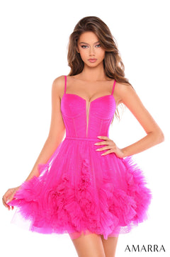 A model wears a neon pink ruffled tulle corset dress with sparkly details and a voluminous skirt.