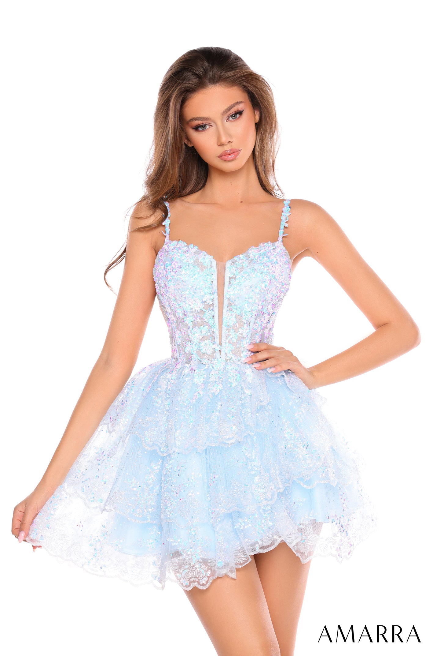 Model wears a short, light blue sequined cocktail dress with a sweetheart neckline and full, ruffled skirt.