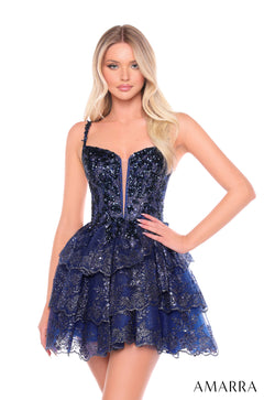 A blonde model wears a navy sequined, tiered party dress with a sweetheart neckline and asymmetric straps.