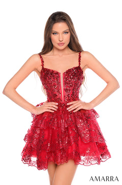 A model wears a sparkling red sequin cocktail dress with a fitted bodice and layered, scalloped skirt.