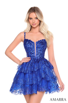 A model wears a Royal Blue sequined, tiered mini dress with a plunging neckline by Amarra.