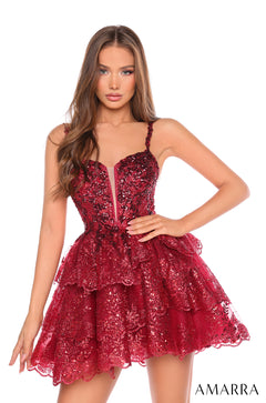 A woman wears a wine-colored sequined, tiered mini dress with sweetheart neckline from Amarra.
