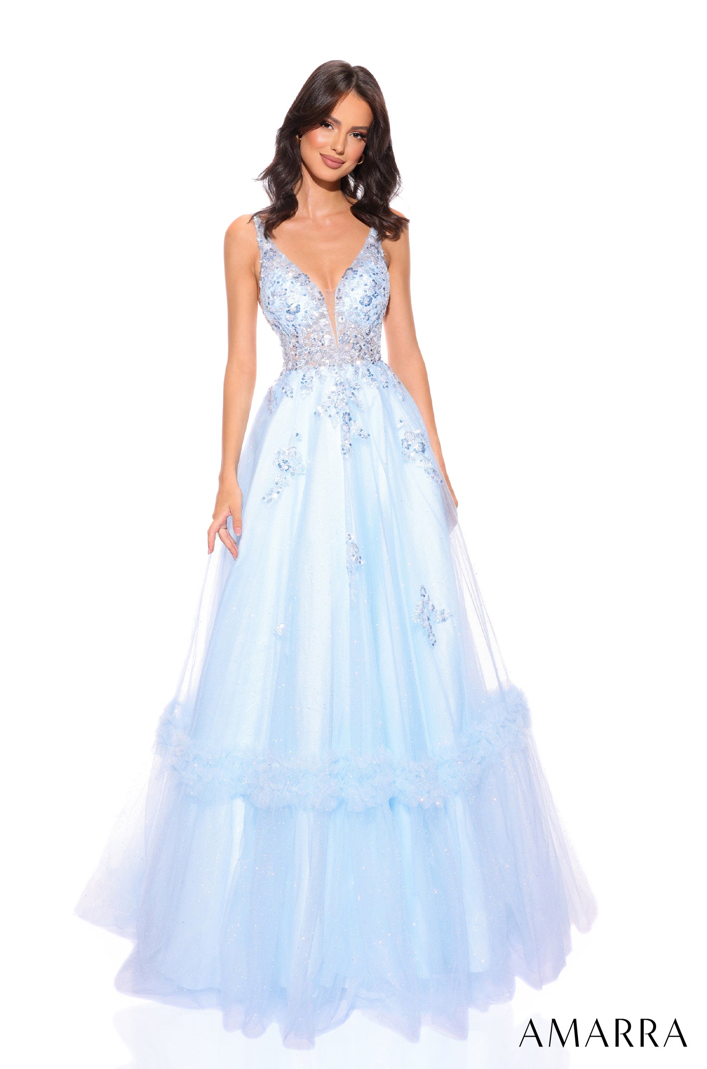A model wears a light blue floor-length ball gown with floral lace bodice and tiered tulle skirt.