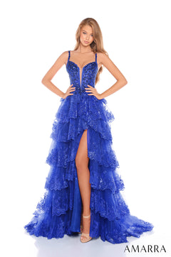 A royal blue, sequined, tiered gown with a plunging neckline and high leg slit, styled on a model.