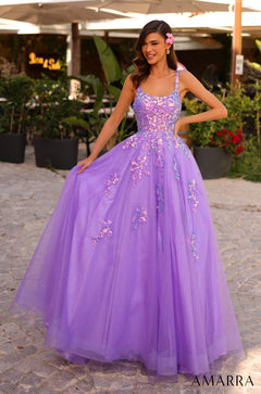 A woman wears a sparkling dark lilac ball gown with floral embellishments, standing in a garden setting.