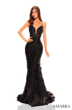 A slender model wears a Black sequined and feathered mermaid gown with thin straps.