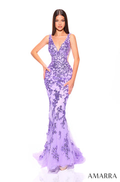 A woman wears a form-fitting lilac gown with delicate floral lace overlay and a dramatic mermaid silhouette.