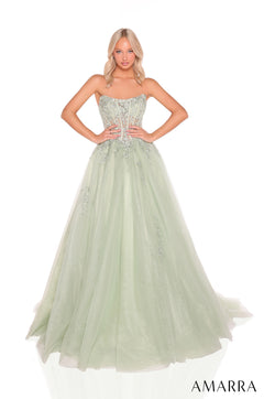 A model wears a strapless sage green ball gown with an embellished corset bodice and flowing tulle skirt.