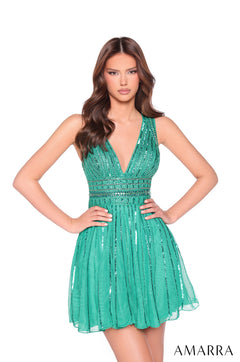 A slender model wears a jade green, sequin-embellished halter cocktail dress with a flared skirt.