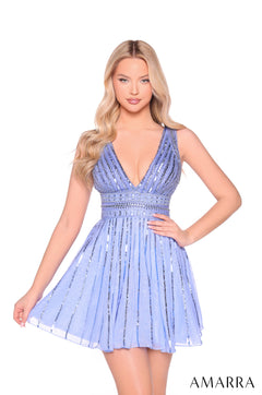 A model wears a short, sparkly periwinkle cocktail dress with a deep V-neckline and flared skirt by Amarra.