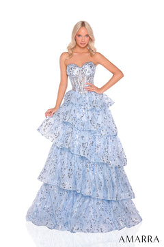 A model wears a strapless, tiered Light Blue ball gown with sparkling sequin details by Amarra.