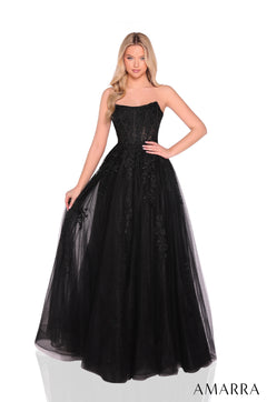 A model wears a strapless Black ballgown with lace detailing and a full tulle skirt.