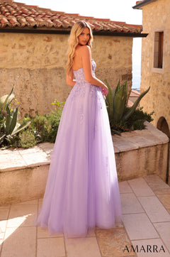 A woman wears a strapless lavender ball gown with floral embellishments.