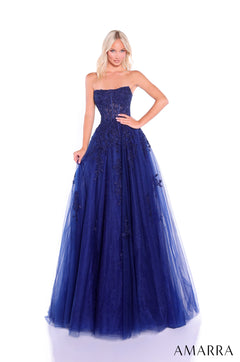 A strapless ballgown in navy tulle with intricate lace appliqués, styled on a model against a white background.