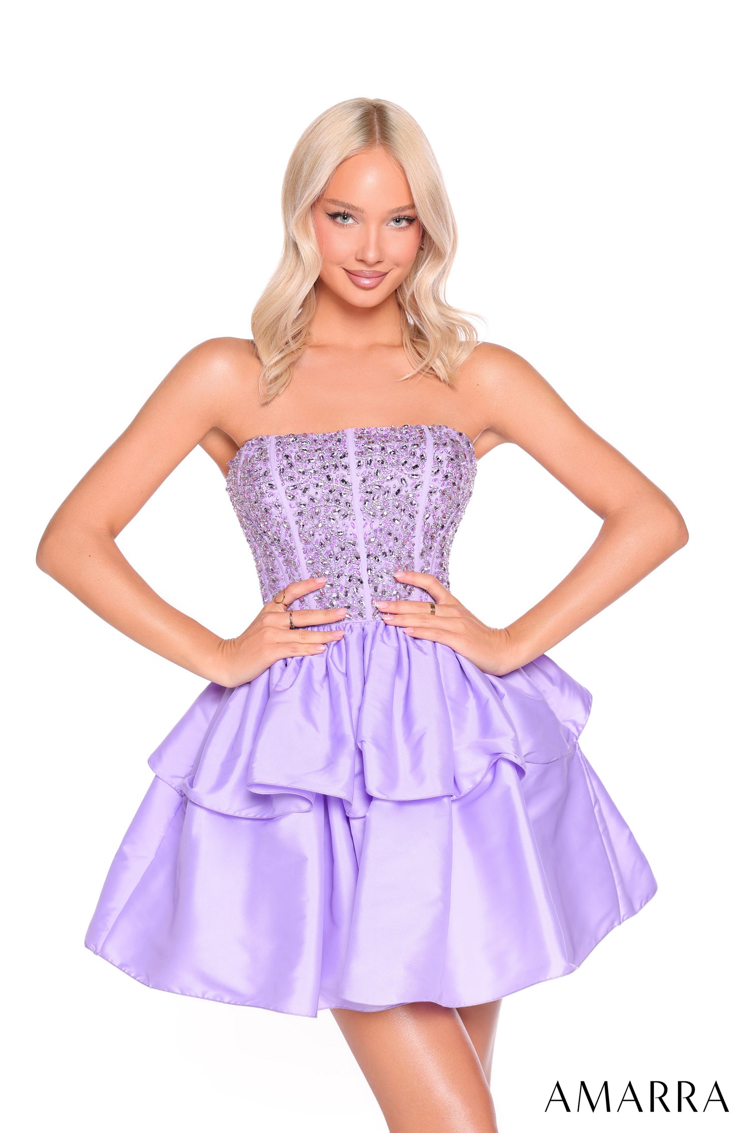 A woman models a strapless lilac cocktail dress with a beaded bodice and tiered skirt by Amarra.
