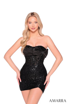 A woman in a strapless black sequin mini dress stands confidently against a white background.