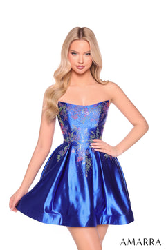 A model wears a strapless, embellished Royal Blue satin party dress with floral details and a full skirt.